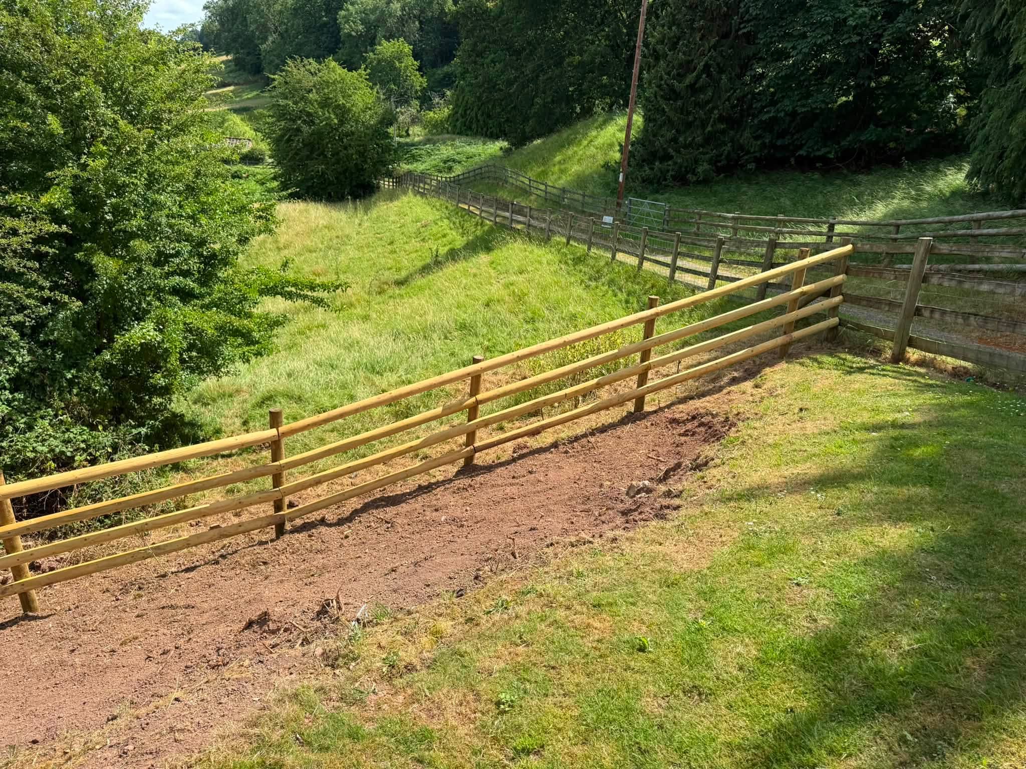 The completed new fence running along the cleared boundary