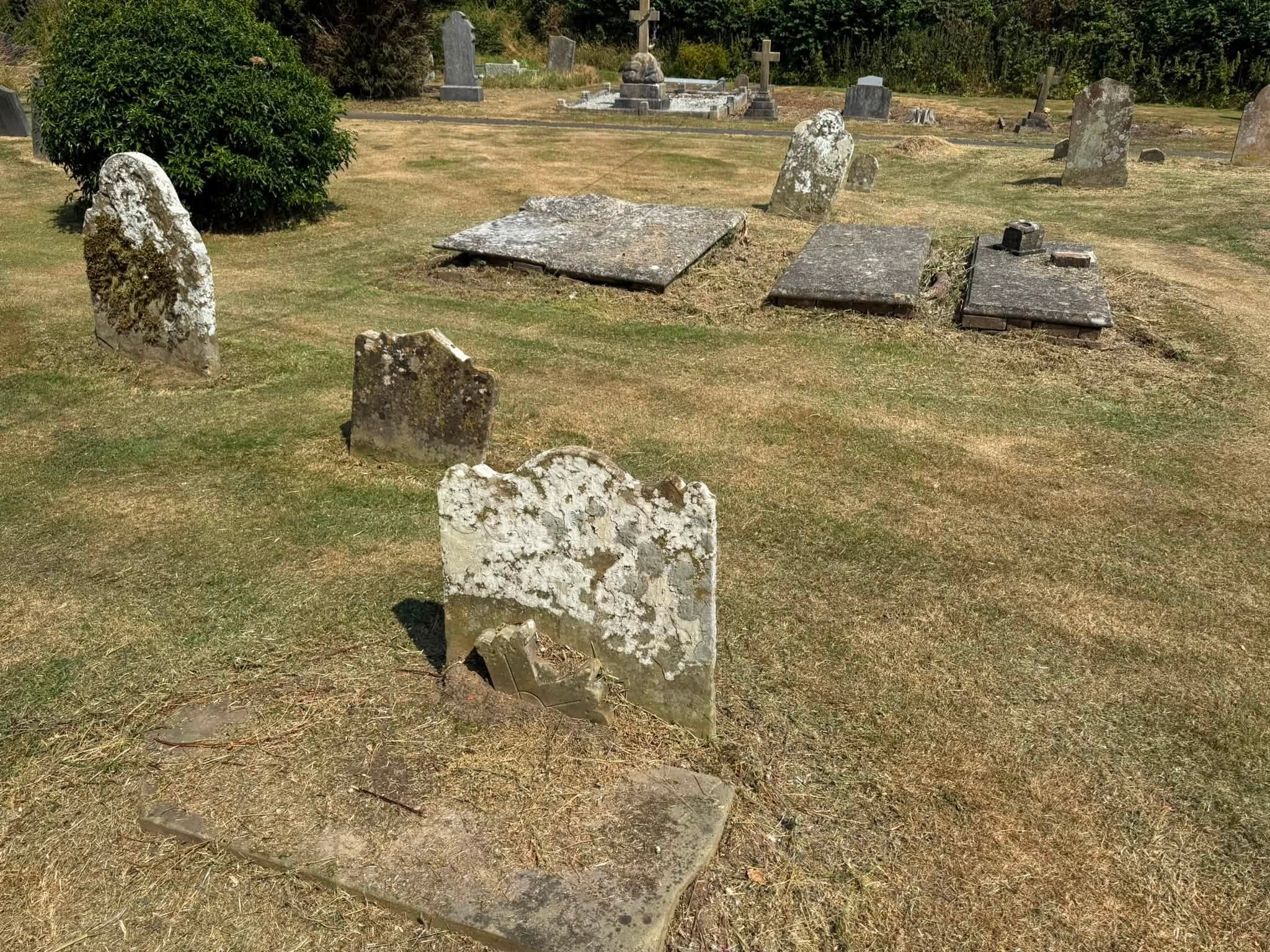 Strimming carefully around the headstones and church building
