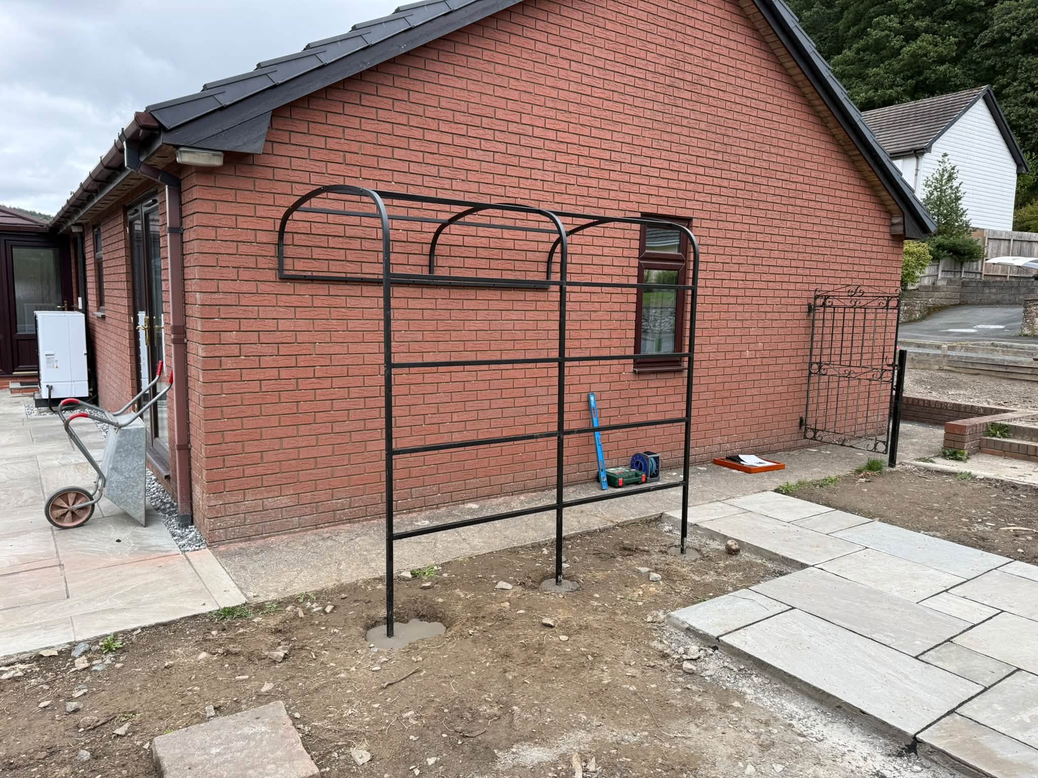 The custom garden arch fitted and concreted into place
