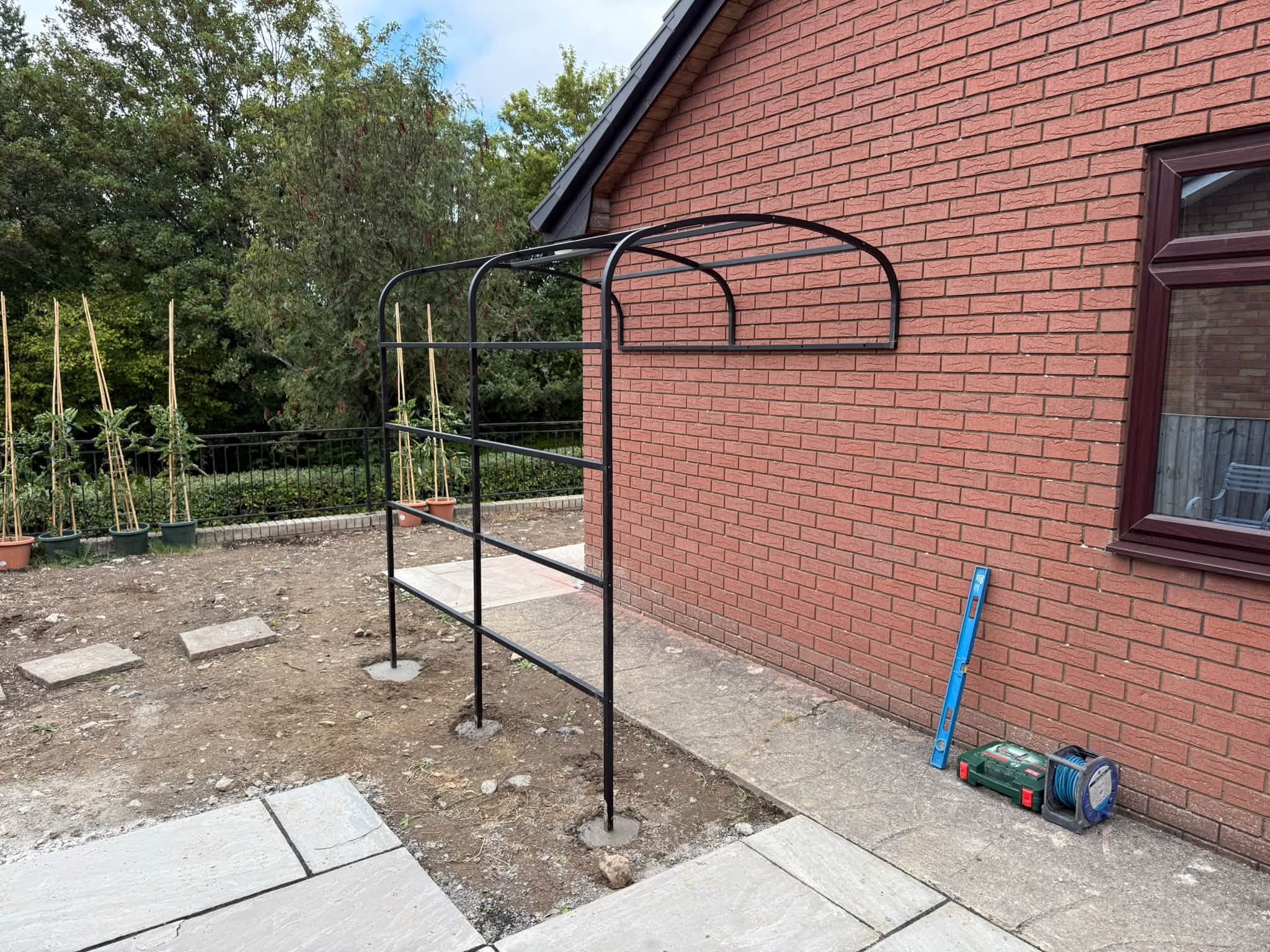 Concreting the garden arch supports in place